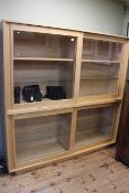 Ercol sliding glazed door bookcase/display, of double height with glass and wood shelves, 1.