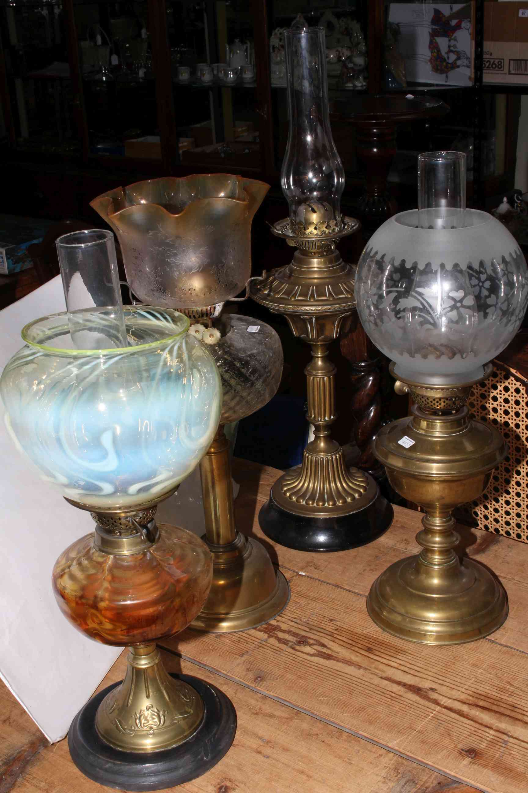 Collection of four late Victorian oil lamps including good vaseline shade.