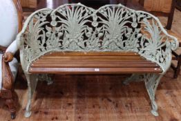 Green painted cast metal framed Coalbrookedale style garden bench.