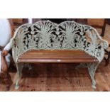 Green painted cast metal framed Coalbrookedale style garden bench.