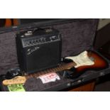 Vintage branded electric guitar with accessories in case, together with a Squier amplifier.
