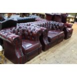 Three piece red leather deep buttoned lounge suite comprising two seater Chesterfield,