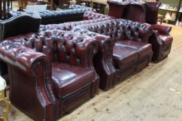 Three piece red leather deep buttoned lounge suite comprising two seater Chesterfield,