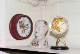 Esso clock, phrenology head and small globe.