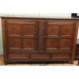 Large oak Arts and Crafts cupboard with double doors above hinged compartment, 1.88m wide, 1.