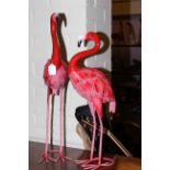 Two metal models of flamingos.