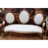 Victorian walnut triple chair back sofa with serpentine front seat.