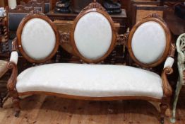 Victorian walnut triple chair back sofa with serpentine front seat.