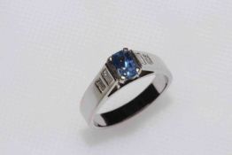 Sapphire and diamond ring with elevated rectangular sapphire flanked by table cut diamonds,