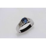 Sapphire and diamond ring with elevated rectangular sapphire flanked by table cut diamonds,