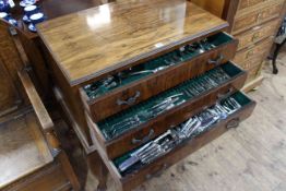 Part canteen of silver plated cutlery enclosed in a walnut table with drawers, 79cm by 85cm.