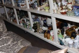 Full shelf of china, glass, ornaments, glass and stoneware bottles, teawares, etc.