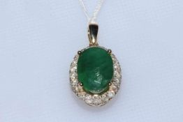 Emerald and diamond pendant with 5.6 carat oval emerald bordered with 0.