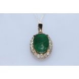 Emerald and diamond pendant with 5.6 carat oval emerald bordered with 0.