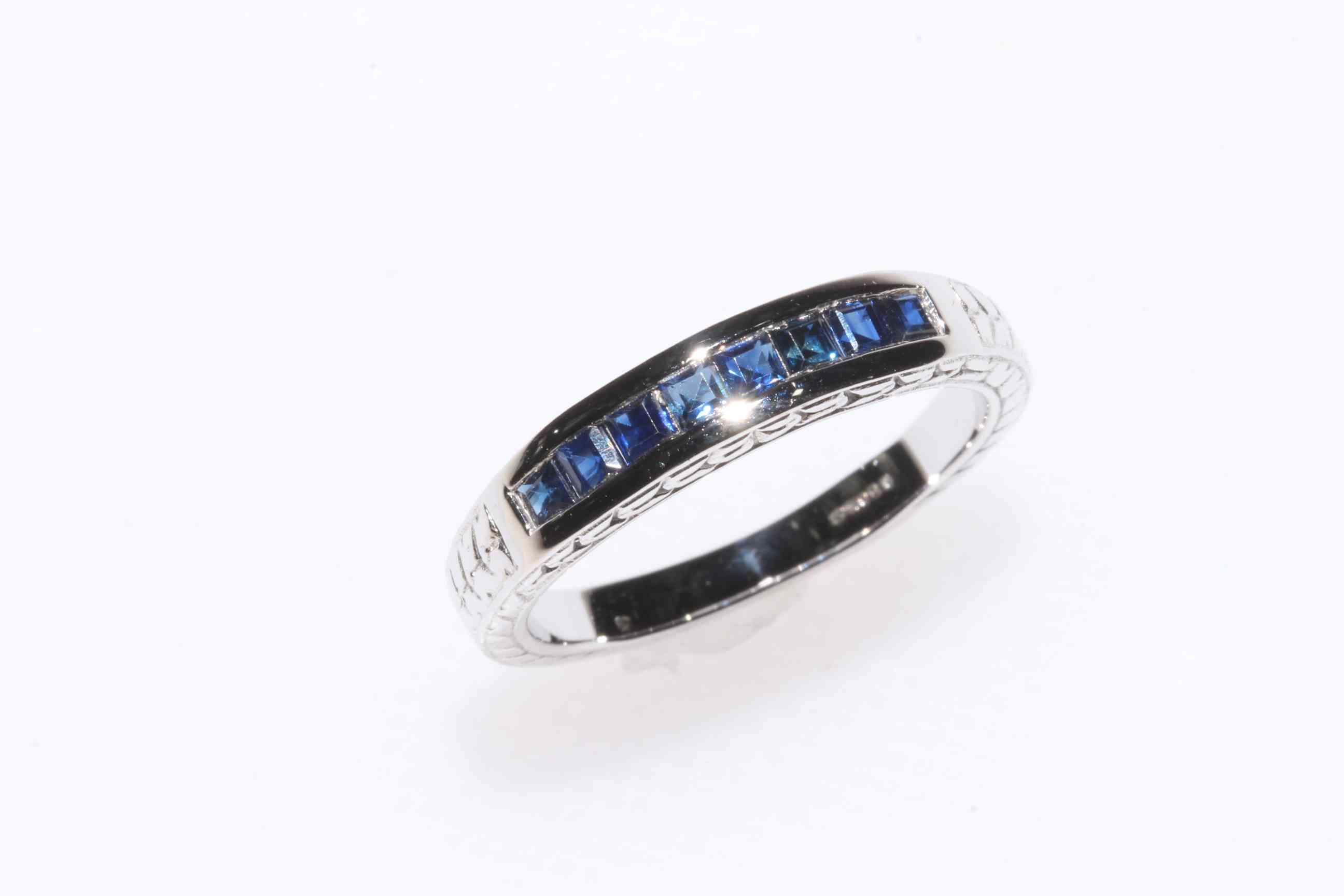 Sapphire square cut eight stone ring set in 9 carat white gold, size O.