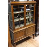 Early 20th Century mahogany cabinet having two glazed panel doors above two cupboard doors on