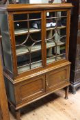 Early 20th Century mahogany cabinet having two glazed panel doors above two cupboard doors on