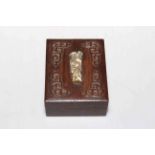 Oriental carved wood box with ivory figure to lid, 10cm by 8cm.