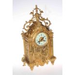 Highly ornate gilt metal mantel clock with enamel dial, 47cm by 24cm.