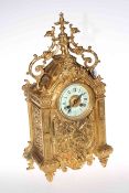 Highly ornate gilt metal mantel clock with enamel dial, 47cm by 24cm.