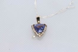 14 carat gold, brilliant cut tanzanite and 18 brilliant cut diamonds pendant,