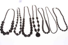 Seven black bead necklaces and one bracelet (Jet?).
