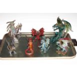 Collection of seven metal dragon ornaments.