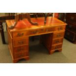 Yew eight drawer pedestal desk, 75.5cm by 122cm.