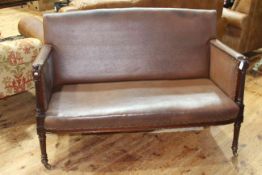 19th Century buttoned hide sofa on turned reeded legs.