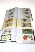 Three postcard albums housing vintage Christmas and New Year greetings postcards,