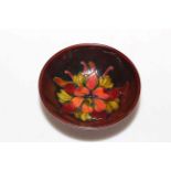 Moorcroft Pottery flambé footed dish decorated with columbine, 14cm diameter.