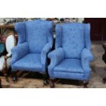 Two similar Edwardian wing armchairs on ball and claw legs.
