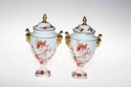 Pair of Coalport 'Indian Tree Coral' lidded vases with gilt rams head handles.