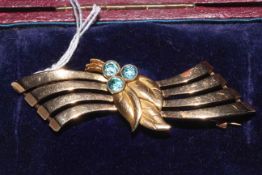 9 carat gold brooch set with three blue stones, 11.2g gross, boxed.