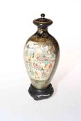 Satsuma Kinkozan Meiji period vase and cover, painted with two panels of figures on mottled blue,