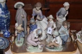 Collection of eight Nao figures and Lladro figure.