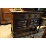 Carved oak buffet cabinet having two drawers above two cupboard doors and undershelf,