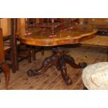 Victorian figured walnut shaped oval top loo table on central pedestal to four scrolled legs,