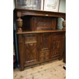 Large carved oak buffet sideboard having four doors and two drawers and carved supports,