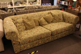 Chesterfield settee in swag decorated fabric.