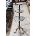 Mahogany three tier stand having three circular shaped scalloped shelves on tripod base, 105cm tall.