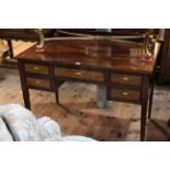 Edwardian mahogany and line inlaid five drawer writing desk raised on square tapering legs,