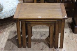 Sherry medium oak nest of three tables in Arts & Crafts style (largest 48cm by 66cm by 48cm).