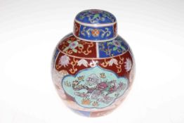 Chinese style ginger jar decorated with dragons and floral panels.