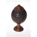 Carved coconut shell box with turned treen lid and base.