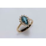 Pear shaped blue topaz, diamond and 9 carat gold ring, size L.