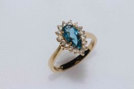 Pear shaped blue topaz, diamond and 9 carat gold ring, size L.