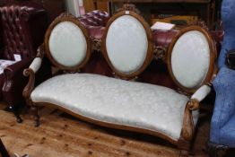 Victorian walnut triple oval panel back settee with serpentine front seat.