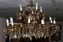 Fifteen branch two tier gilt metal chandelier with crystal glass drops.