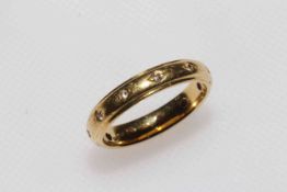 18 carat gold and diamond set band ring, size N.